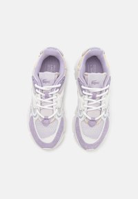 Lacoste sneakers, featuring a mesh and suede design in lavender, white accents, thick rubber sole, and traditional lace-up closure.