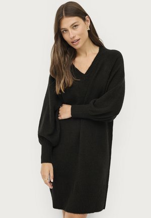 Zwart gebreid sweaterjurk met een V-hals, ballonnenmouwen en ribgebreide manchetten en zoom. Zachte textuur met een losse, ontspannen pasvorm.