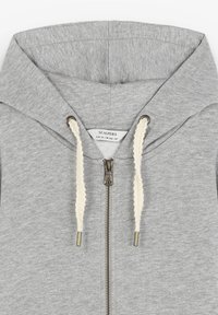 Sudadera gris con cremallera hecha de un tejido suave. Presenta una capucha forrada, cordones gruesos de color crema y una cremallera de metal. Etiqueta en el cuello interior.