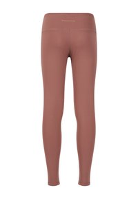Leggings i en støvet rosefarve, lavet af strækstof med en glat tekstur. Har en høj talje og minimal branding på bagsiden.