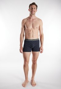 Dark blue boxer briefs with a subtle geometric pattern, elastic waistband, and logos. Smooth fabric with a snug fit, suitable for daily wear.