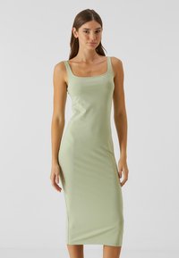 Robes moulantes vert menthe, à encolure carrée, en tissu lisse et extensible, avec une longueur midi et sans motifs ni accents visibles.