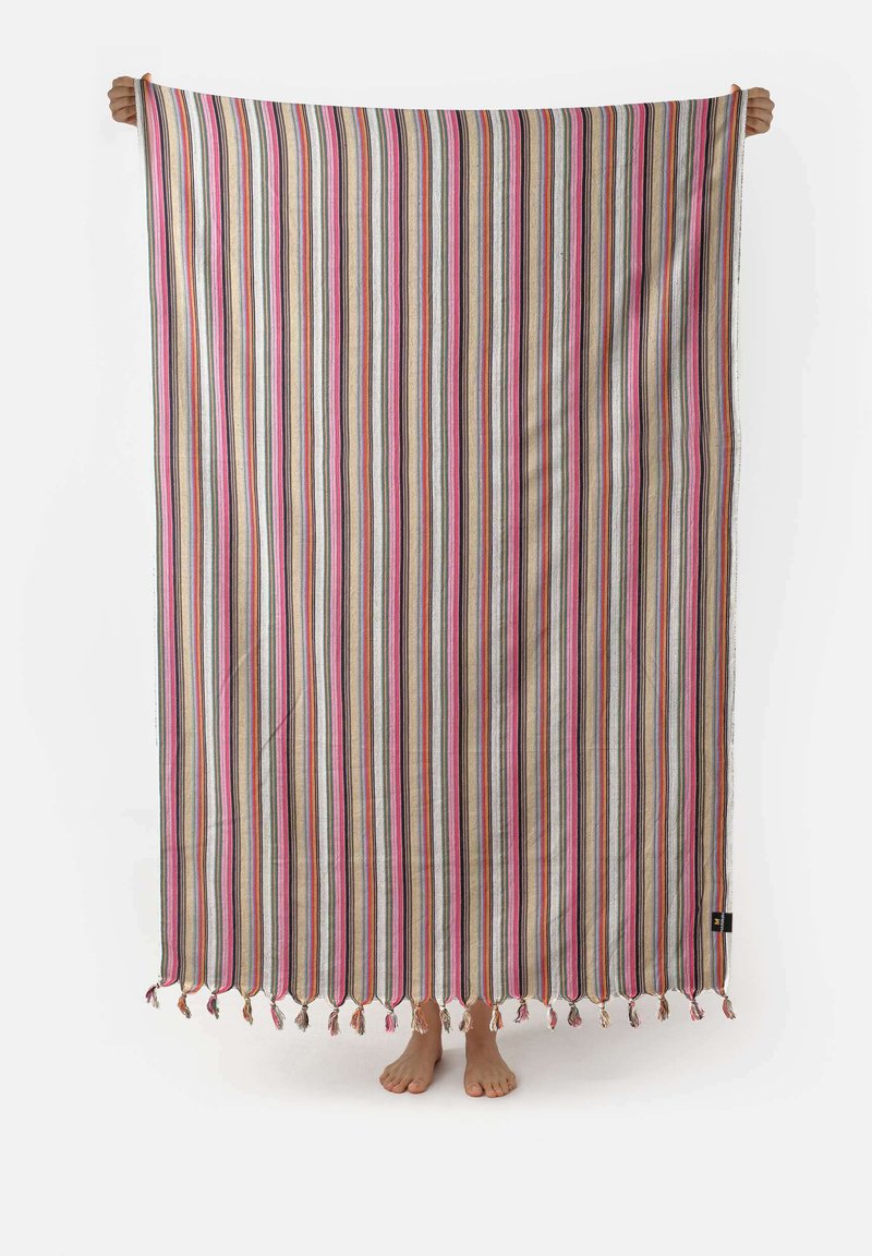 Striped blanket in beige, pink, green, and blue with tassels at the bottom. Lightweight fabric; rectangular shape, held up by hands.