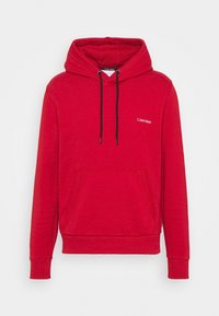 Sudadera con capucha roja en mezcla de algodón con bolsillo frontal, mangas largas, puños de canalé y cordones. Presenta el logo de 'Calvin Klein' en blanco.