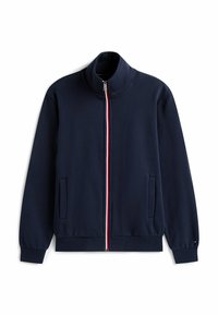 Giacca sportiva navy con colletto alto, zip completa, dettaglio a strisce rosse e bianche lungo la zip e tasche laterali. Materiale morbido.