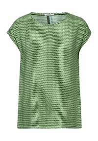 Blusa verde a maniche corte con un motivo testurizzato di punti verdi scuri su uno sfondo verde chiaro. Collo tondo e vestibilità ampia.