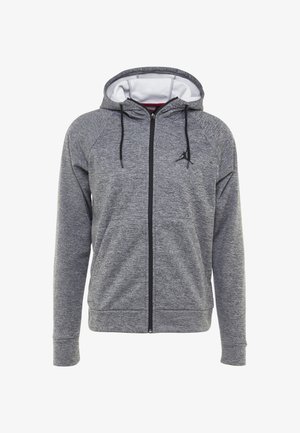 Grauer Kapuzenpullover mit durchgehendem Reißverschluss, schwarzen Kordeln, zwei Fronttaschen und einem kleinen schwarzen Logo auf der linken Brust, das das weiße Innenfutter der Kapuze zeigt.