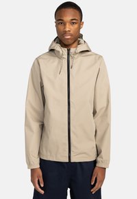 Beige leichte Jacke mit Kapuze, schwarzem Reißverschluss, elastischen Bündchen und Kordeln. Glatte Textur ohne sichtbare Muster oder Logos.