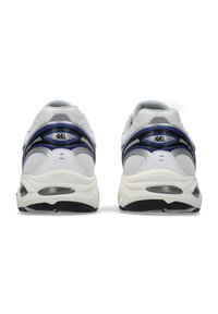 White athletic shoes with mesh and synthetic upper, featuring a blue accent and GEL cushioning. Black rubber outsole with tread pattern.