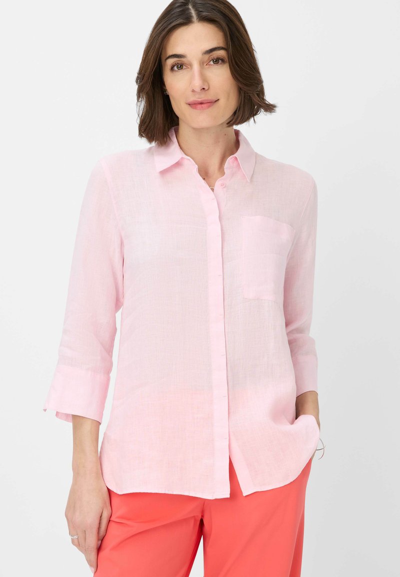 Light pink linen shirt with a collar, button-down front, long sleeves, and a single chest pocket. Soft texture and relaxed fit.