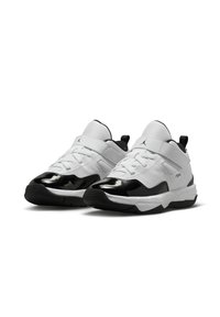 Witte sportschoenen met zwarte gepatineerde leren accenten, gaasstof en een haak-en-lusband. Ontworpen met een ronde neus en een gestructureerde zool.