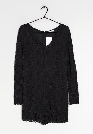 Sort blonde bodysuit med lange ærmer, V-udskæring, tekstureret blomstermønster og bølget kant. Lynlås lukning på ryggen og synlig mærkat.