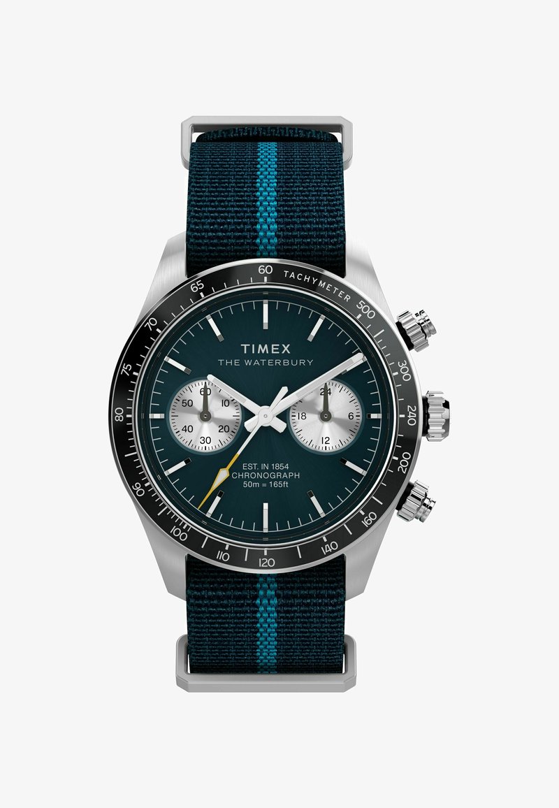 A Timex Waterbury óra rozsdamentes acél tokot, kék számlapot, krónográf funkciókat és egy szőtt tengerészkék szíjat turquoise csíkkal rendelkezik.