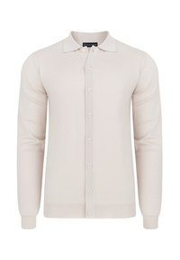 Jasnobeżowy kardigan z długim rękawem, zapinany na guziki, z prążkowanymi mankietami i kołnierzem. Wykonany z miękkiej, teksturowanej tkaniny.