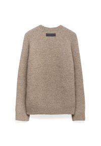 Beżowy sweter wełniany z rękawami raglanowymi, ściągaczami na mankietach i u dołu, z małą prostokątną metką z tyłu przy dekolcie. Miękka tekstura.