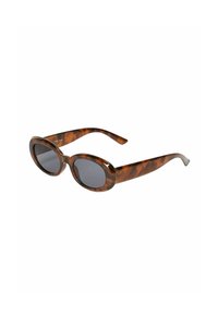 Lunettes de soleil en écaille de tortue avec des verres ovales surdimensionnés, une teinte gris foncé, des branches élégantes et une finition lisse et brillante.