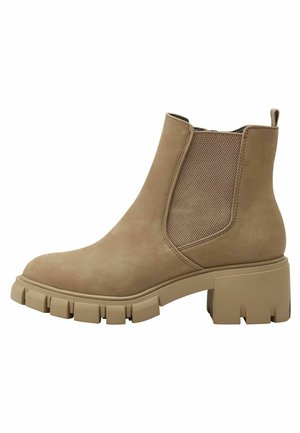Beige suede ankle boot with elastic side panels, chunky rubber sole, and textured detailing on the heel and upper.