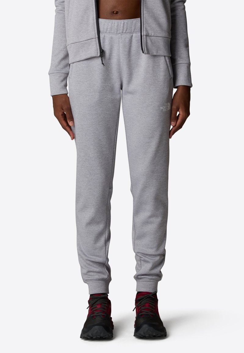 Grijze sweatpants met een elastische tailleband en taps toelopende benen, gemaakt van een zachte stof, met een subtiel logo op de zijkant.