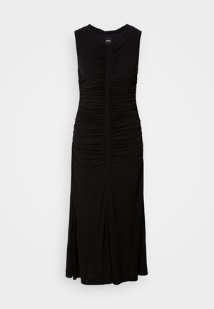 Black sleeveless dress made of stretchy fabric; ruched detailing along the sides; fitted bodice; flared hem; simple V-neck design.