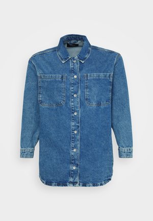Denim shirt in medium blue, featuring a button-up front, pointed collar, two chest pockets, and long sleeves with buttoned cuffs.