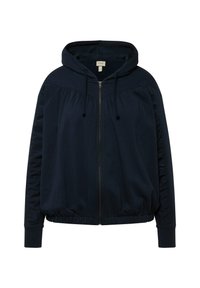 Sweat à capuche bleu marine avec fermeture éclair à l'avant, détails froncés sur les côtés et poignets côtelés. Tissu doux et coupe décontractée.