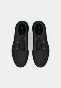 Black leather shoes with a smooth finish, round toe, and contrasting stitching; features metal eyelets and laces for secure fit.