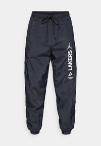 Marineblå letvægts joggers med elastisk talje og snoretræk, side lommer og hvide trykte logoer på venstre ben.