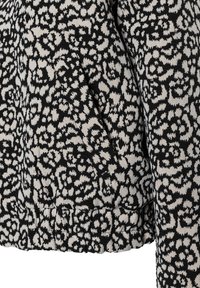 Schwarz-beige gemusterte Jacke aus strukturiertem Stoff mit einem gerippten Bund und Seitentaschen.