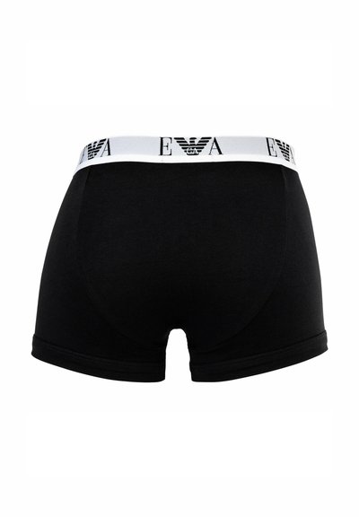 Boxer aderenti in cotone nero con fascia elastica bianca in vita decorata con il logo. Il design presenta una texture liscia e una silhouette aderente.