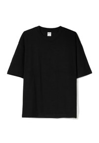 T-shirt in cotone nero con vestibilit�à rilassata, maniche corte e colletto rotondo. Nessun motivo o dettagli. Texture liscia. Design semplice.