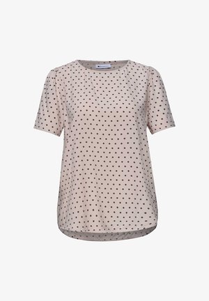 Blusa beige a maniche corte con scollo rotondo e piccoli pois neri distribuiti uniformemente, con un orlo leggermente arrotondato.