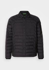 Black puffer jacket with a button-front closure, horizontal quilted design, and a left sleeve accent pocket. Made of water-resistant material.