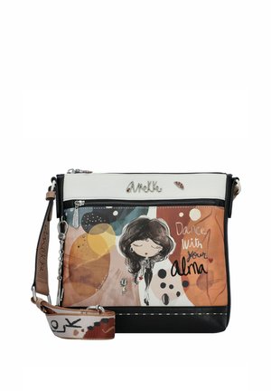 Sac en bandoulière présentant un design imprimé multicolore avec un personnage de dessin animé, agrémenté d'une fermeture éclair blanche et d'une base noire, sangle en textile.