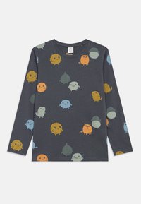 Mørkegrå langærmet skjorte, der viser farverige tegneseriefigurer i forskellige former og størrelser, herunder runde og fluffy design med smilende ansigtstræk.