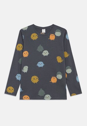 Maglietta a maniche lunghe grigia scura con personaggi dei cartoni animati colorati di varie forme e dimensioni, tra cui design rotondi e soffici, con volti sorridenti.