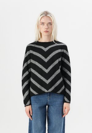 Black and gray chevron-patterned sweater with a crew neckline, long sleeves, and a relaxed fit, made from a soft textured fabric.