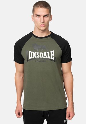 Olivengrünes T-Shirt mit schwarzen Raglanärmeln. Verfügt über ein Löwengrafik und den Text "LONSDALE LONDON" in Weiß. Baumwollmaterial mit glatter Textur.