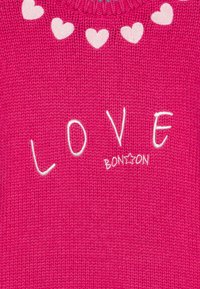 Pink knitted sweater featuring a round neckline, white heart patterns, and embroidered text reading "LOVE" with "BON☆ON" below it.