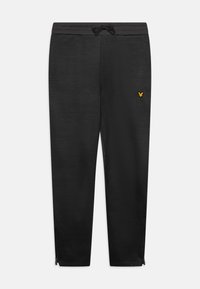 Black joggers made from soft fabric, featuring an elastic waistband with drawstring, side pockets, and a small gold logo near the hip.