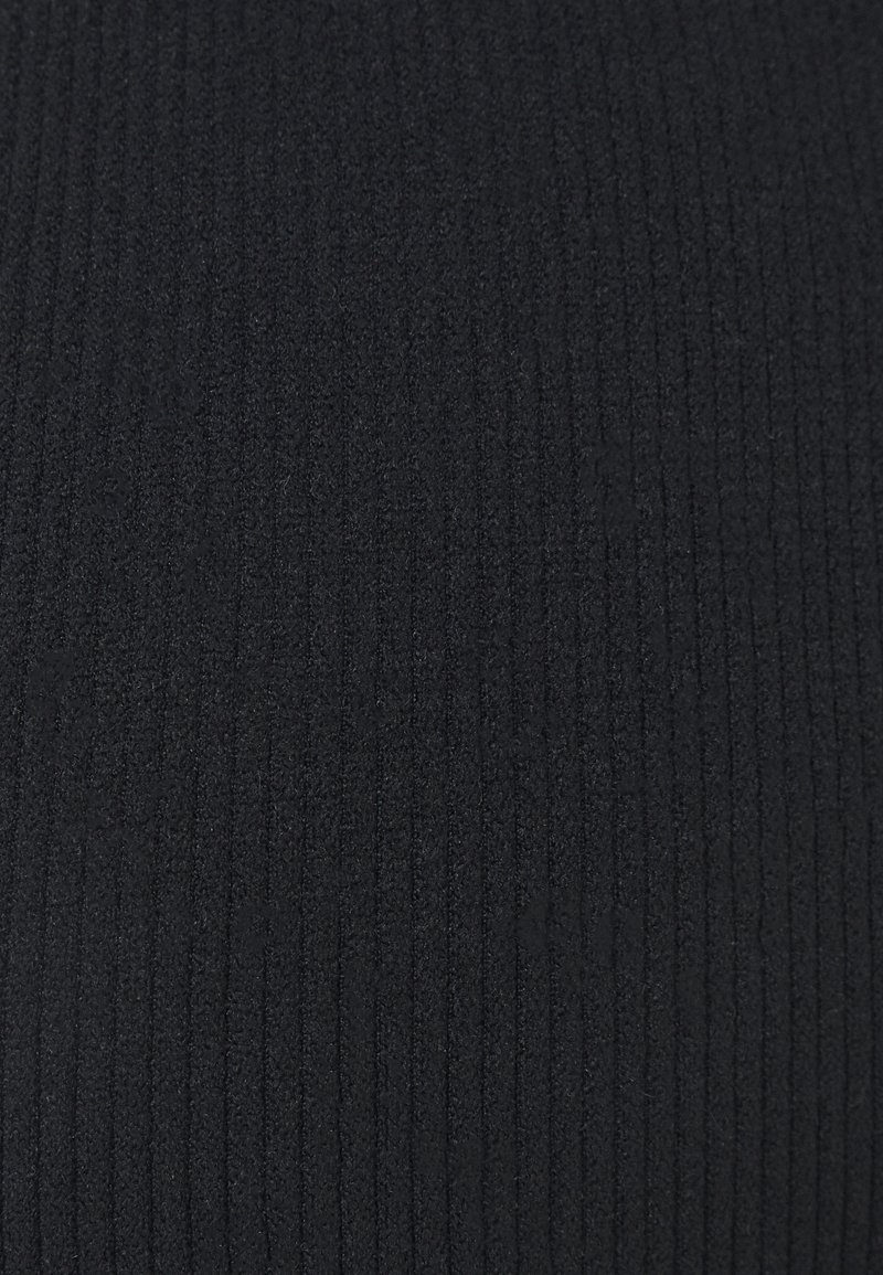 Textura de tela de punto de ribete negro con líneas verticales y un detalle de superficie suave y ligeramente peludo.