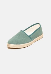 Green canvas espadrille shoe with a rounded toe, jute sole, and a simple, unadorned design. The upper has a textured finish.