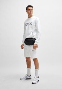 BOSS HEADLO - Spodnji deli trenirk - white