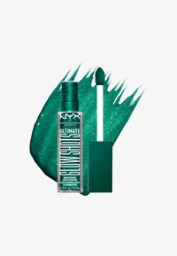 Fard à paupières liquide vert dans un tube transparent avec un applicateur de précision. L'arrière-plan présente une éclaboussure de peinture pailletée verte vibrante.
