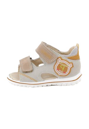 Sandalo beige e marrone chiaro per bambina/o con due cinturini regolabili in velcro e una toppa decorativa sul lato per uso quotidiano.