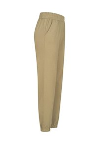 Pantalons de survêtement beige avec une taille élastique et des poches latérales. Les poignets sont resserrés pour un ajustement confortable, fabriqués à partir d'un matériau doux et extensible.
