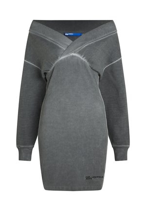 Šedé oversize šaty s hlubokým V výstřihem, dlouhými rukávy a žebrovanými manžetami. Vyrobeny z měkké látky s mírně texturovaným povrchem. Obsahují detail s logem.