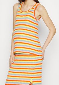 Randig tanktopp och kjol i flera färger med orange, gult, blått och rosa. Mjuk textur och avslappnad passform.