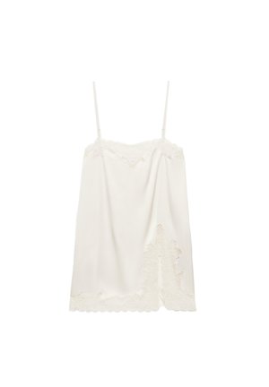 Camisole di seta bianca con sottili spalline regolabili e rifinitura in pizzo floreale sullo scollo e sull'orlo.