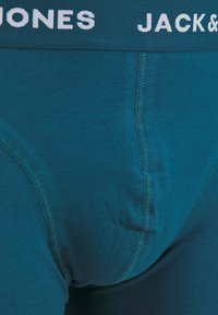 Teal cotton boxer briefs with a white elastic waistband labeled "JACK & JONES." Features flat seams and a snug fit.