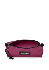 Eastpak pencil case, pink nylon exterior, black zipper with pull tab, and logo patch. Open design with a smooth interior, compact shape.